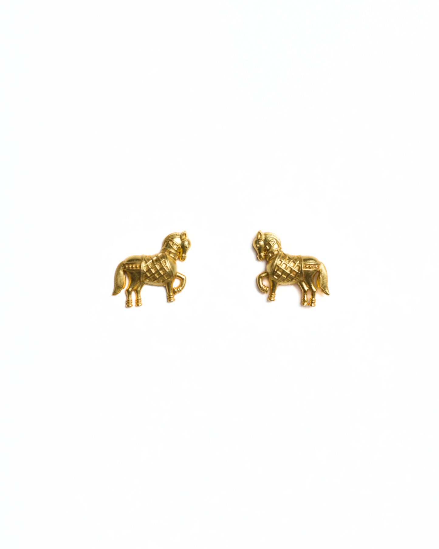 Small gold horse stud earrings with prancing leg and detailed saddle texture, polished finish, minimal white background.