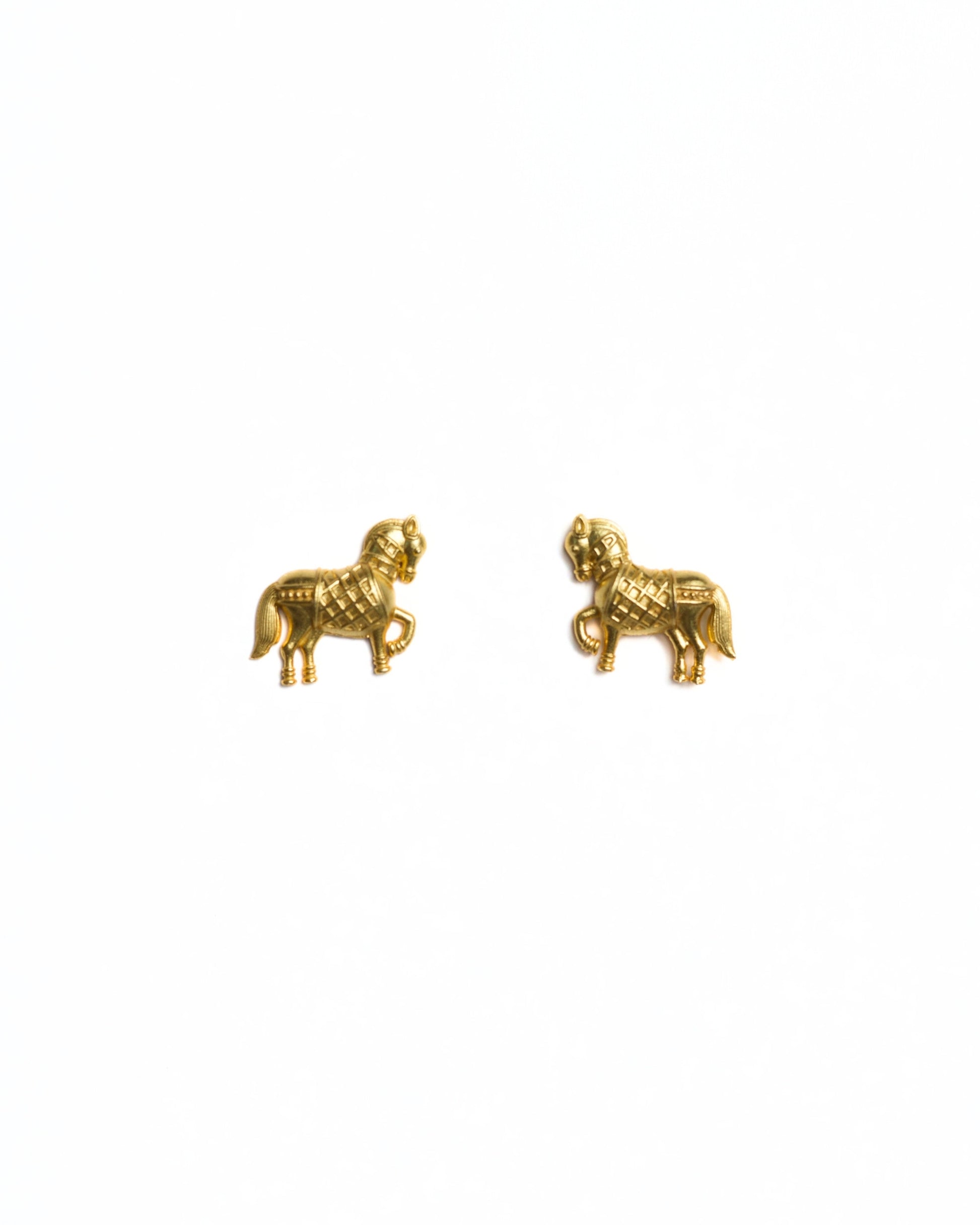 Small gold horse stud earrings with prancing leg and detailed saddle texture, polished finish, minimal white background.