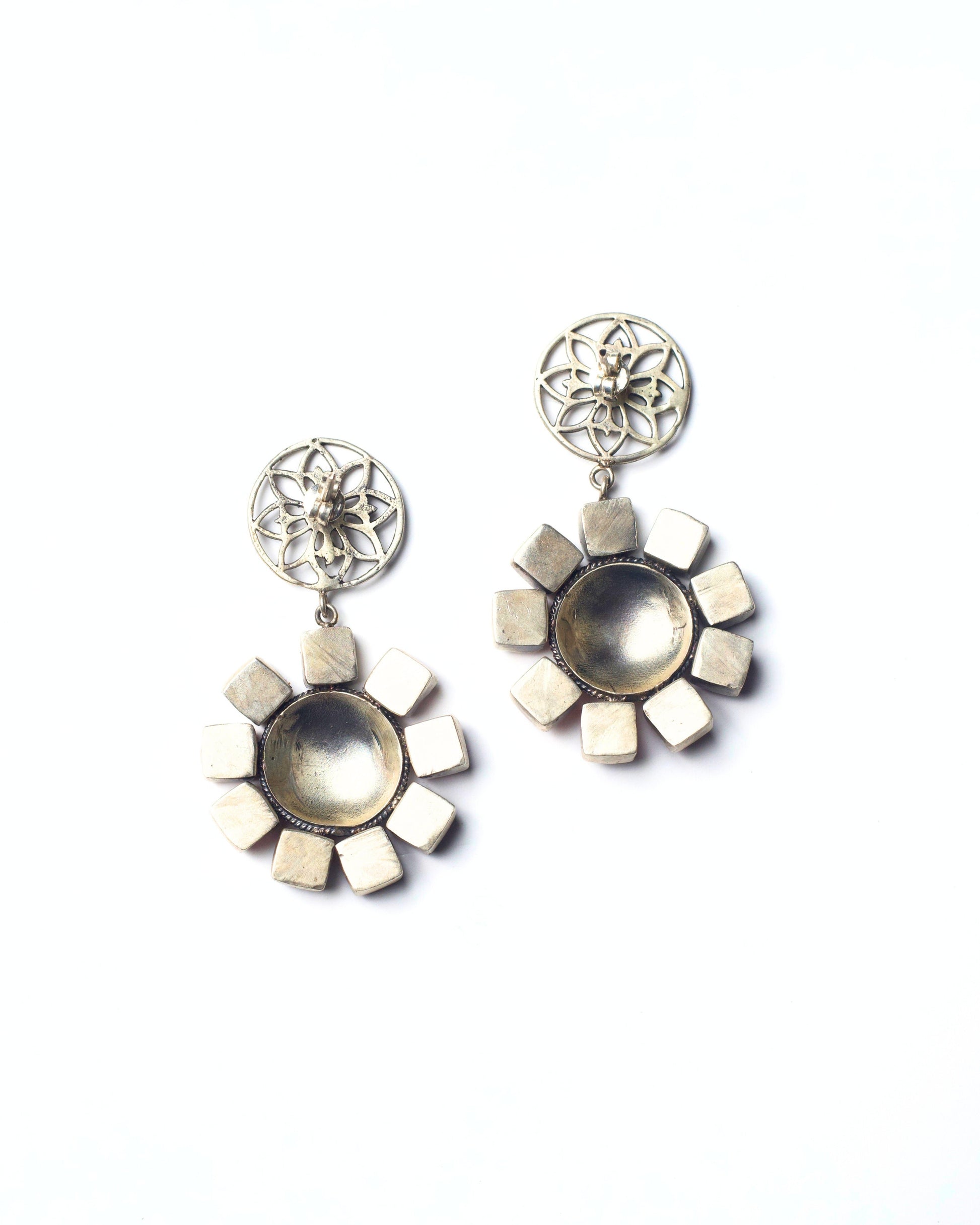 Back view of The Blush Halo Earrings showing the smooth silver backing, stone settings, and hanging construction of the circular halo design.