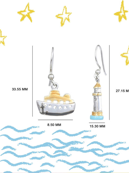 Sail & Stay Danglers by Naksa—mismatched nautical earrings featuring a ship and lighthouse in hand-enameled 925 silver with gold and blue accents.