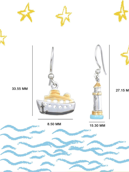 Sail & Stay Danglers by Naksa—mismatched nautical earrings featuring a ship and lighthouse in hand-enameled 925 silver with gold and blue accents.
