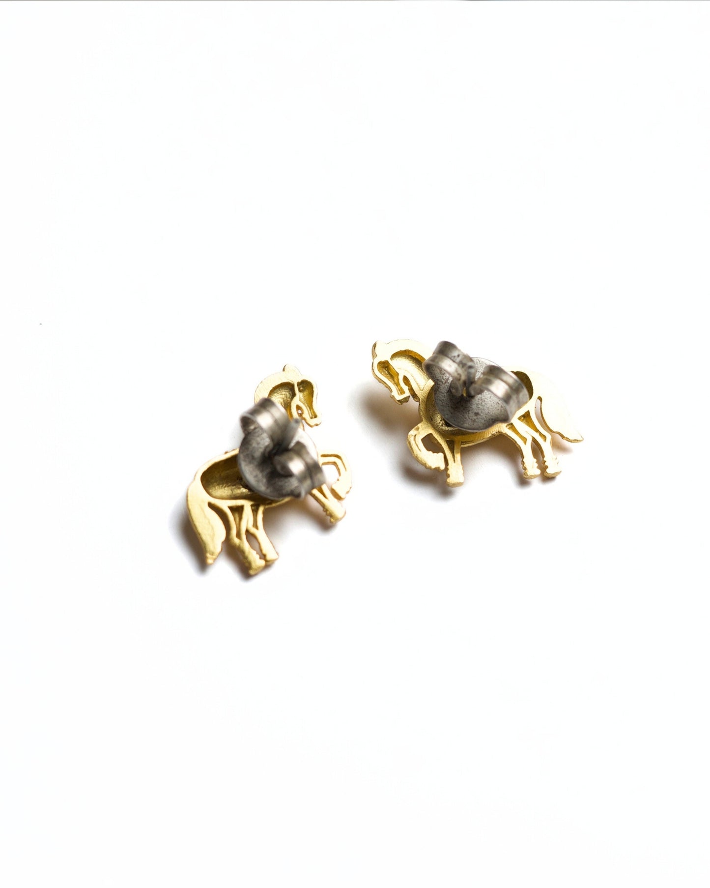 Small gold horse stud earrings with prancing leg and detailed saddle texture, polished finish, minimal white background.