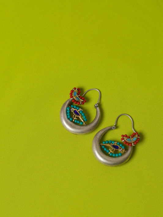 Crescent-shaped 92.5 silver hoop earrings with red and turquoise beads and a hand-painted enamel parrot