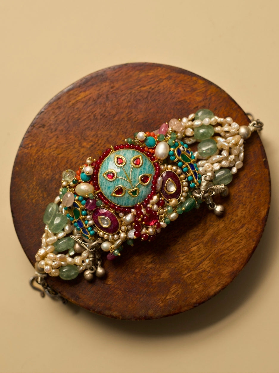 Exquisite pearl and kundan bracelet in pure 925 silver with sea-green, teal, blue, and red stones by Naksa.