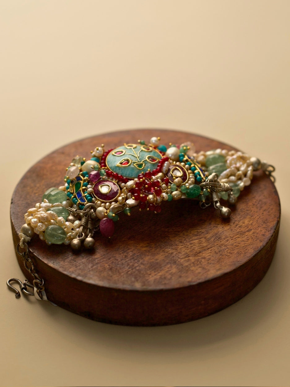 Exquisite pearl and kundan bracelet in pure 925 silver with sea-green, teal, blue, and red stones by Naksa.