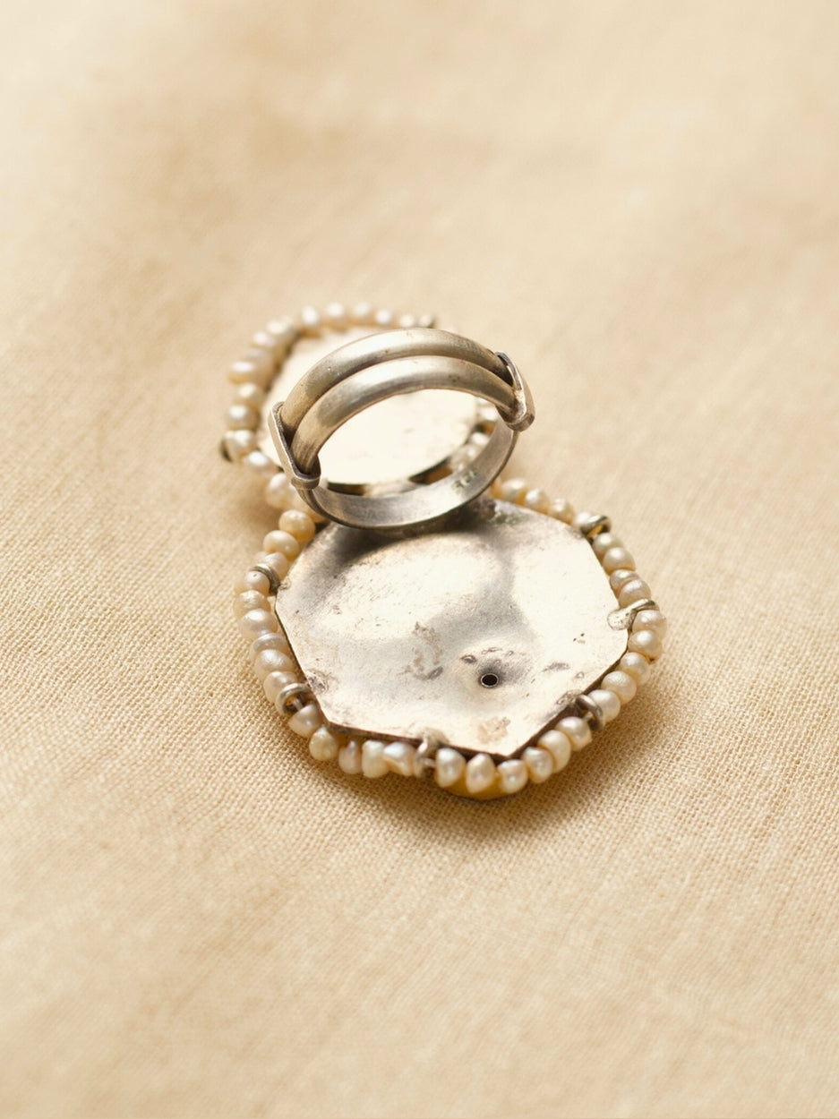 Oxidized 925 silver statement ring with golden dove and lotus motifs, handcrafted by Naksa.
