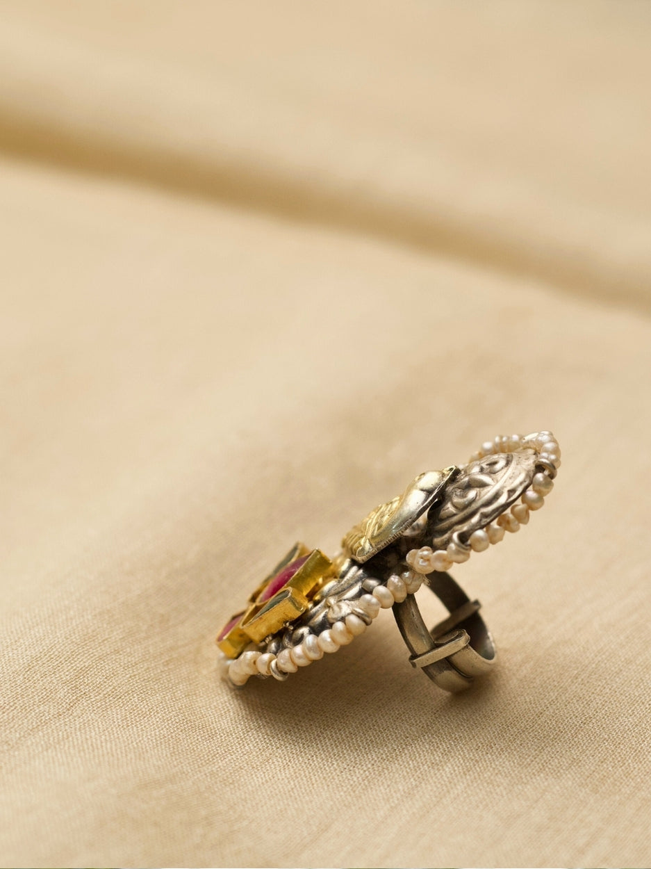 Oxidized 925 silver statement ring with golden dove and lotus motifs, handcrafted by Naksa.