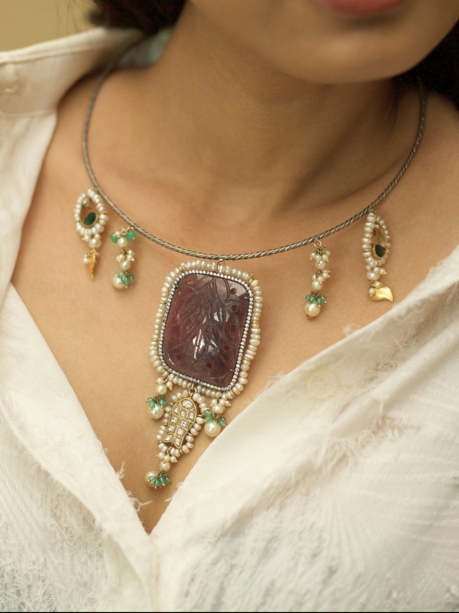 Oxidized 925 silver Hasli necklace set featuring rare carved brown stone, fish charms, pearl drops, and golden leaf earrings by Naksa.
