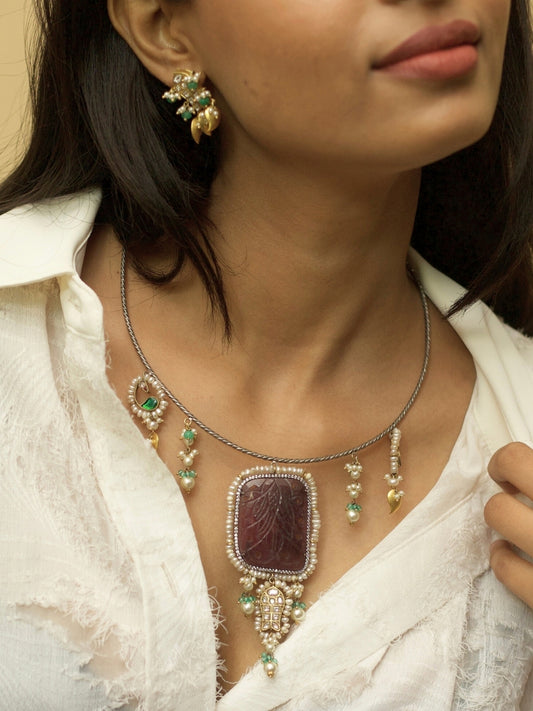 Oxidized 925 silver Hasli necklace set featuring rare carved brown stone, fish charms, pearl drops, and golden leaf earrings by Naksa.
