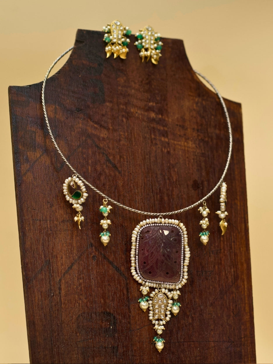 Oxidized 925 silver Hasli necklace set featuring rare carved brown stone, fish charms, pearl drops, and golden leaf earrings by Naksa.