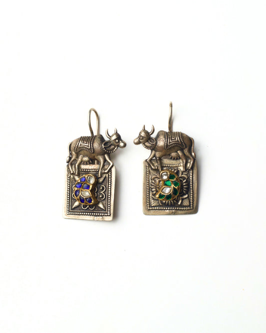 Split Bull Earrings in 925 silver featuring mismatched blue and green stone detailing, sculpted bull motifs, and asymmetrical bird accents