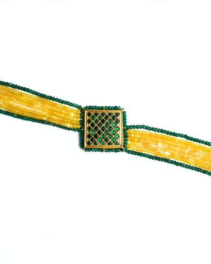 Close-up of a 925 silver gold-polished choker with diagonal yellow and green bead strands and a square lattice centre panel.