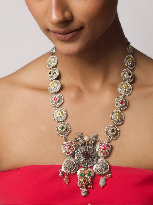 Cows in the Garden Haar, a handcrafted silver necklace featuring cow motifs, floral details, pearls, and multicoloured tikris in gold, green, and pink accents.