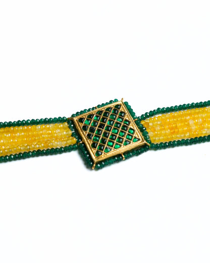 Close-up of a 925 silver gold-polished choker with diagonal yellow and green bead strands and a square lattice centre panel.