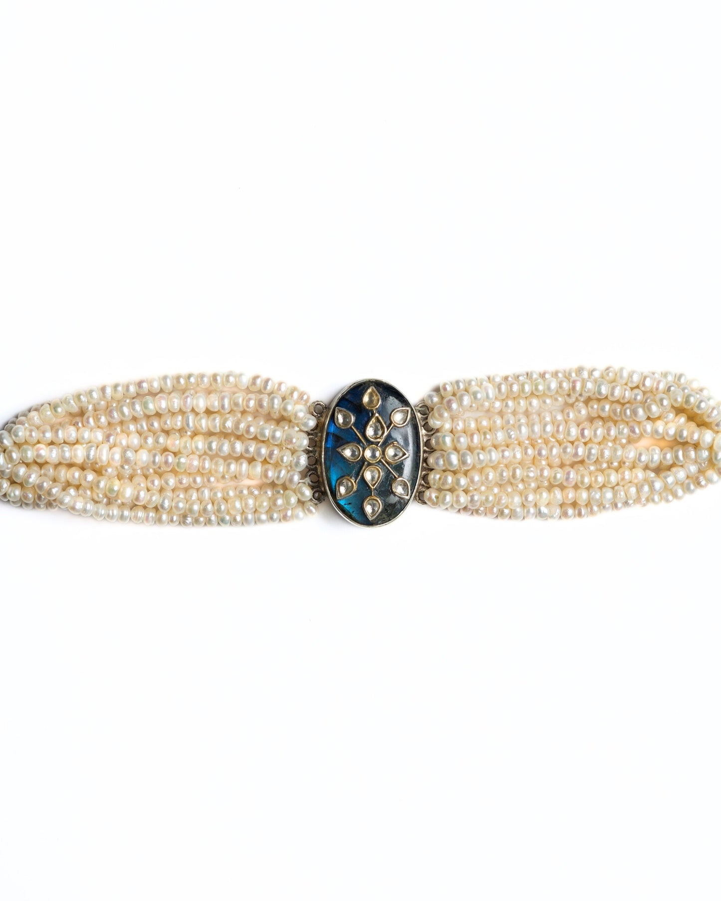 Layered pearl choker in 925 silver with oval oxidised centre and gold-polished kundan floral motif.