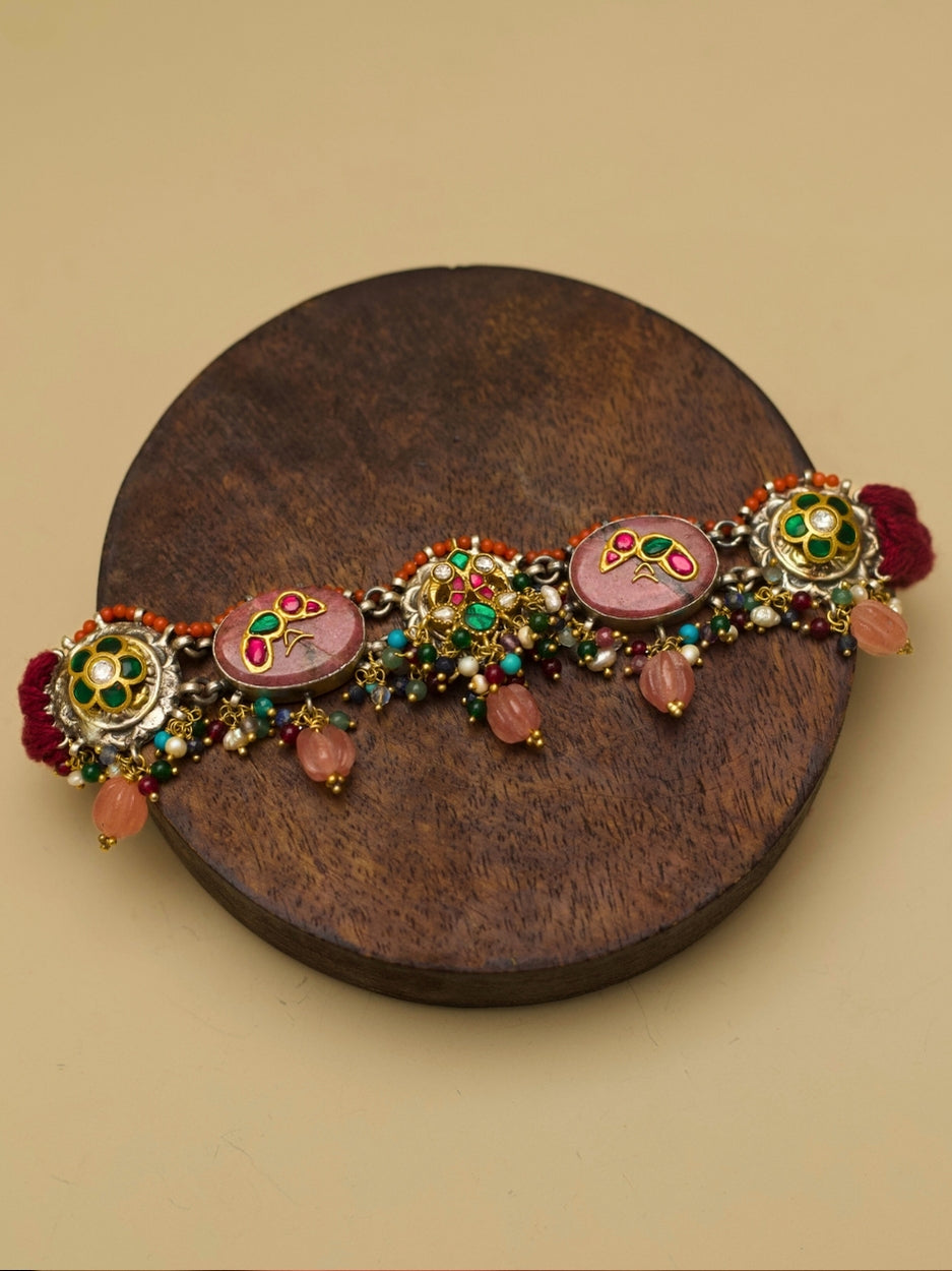 Traditional choker set in pure 925 silver with blush pink stones, kundan parrots and peacocks, and pink pearl drops by Naksa.