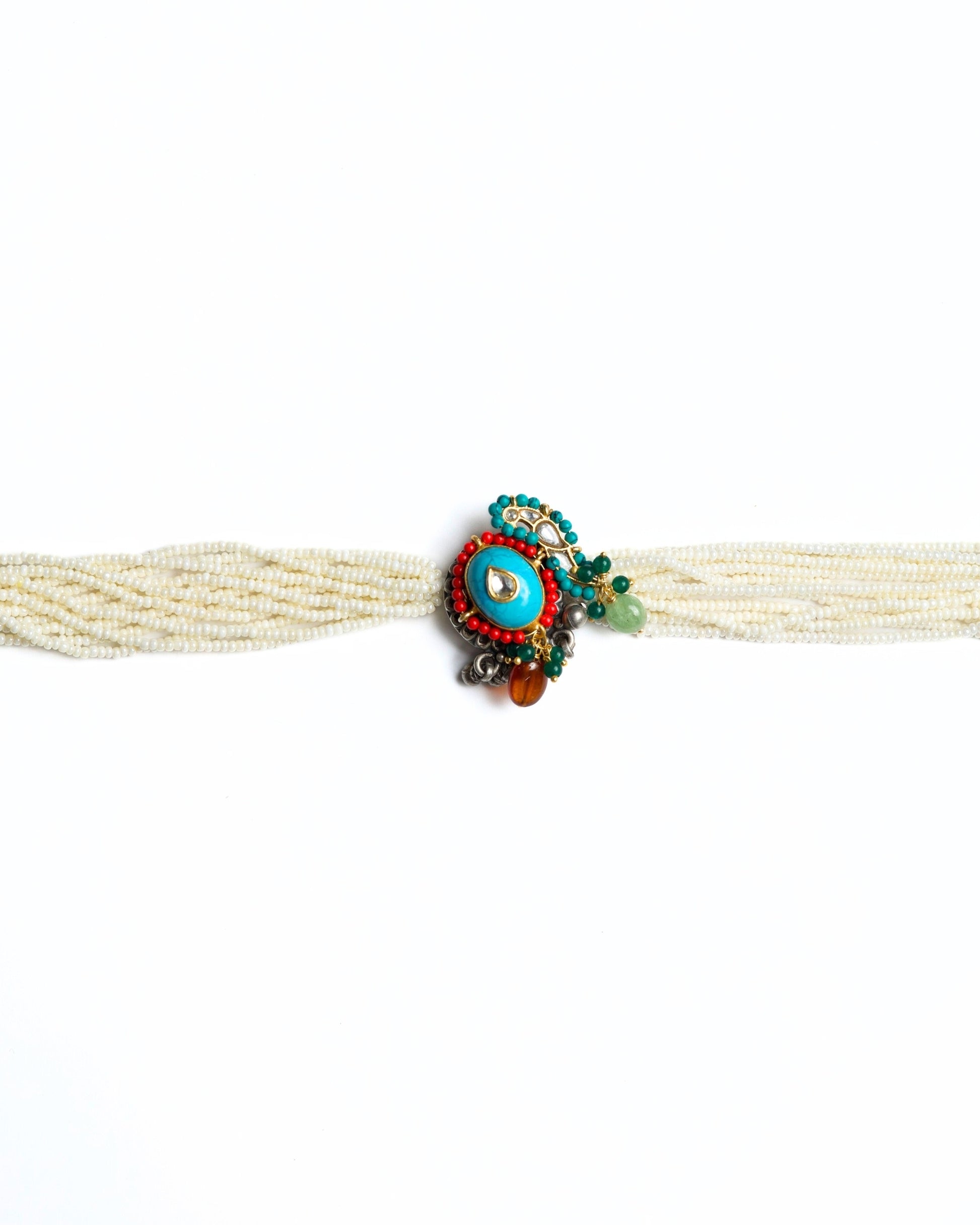 Multi-strand pearl choker with turquoise circular centre, teardrop kundan stone, red bead halo and green stone accents in 925 silver with gold polish.