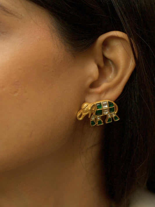 Pure 925 silver elephant-shaped stud earrings with gold polish, moissanite-like stones, and green accents by Naksa.