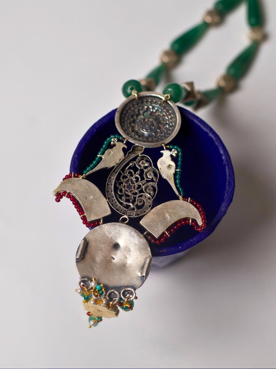 Long handcrafted 92.5 silver necklace with eclectic circular pendants, enamel, moissanite, temple and floral motifs.