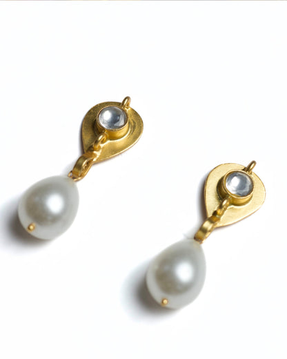 Close-up of gold-polished 925 silver drop earrings featuring a faceted clear stone stud and a suspended white teardrop pearl.