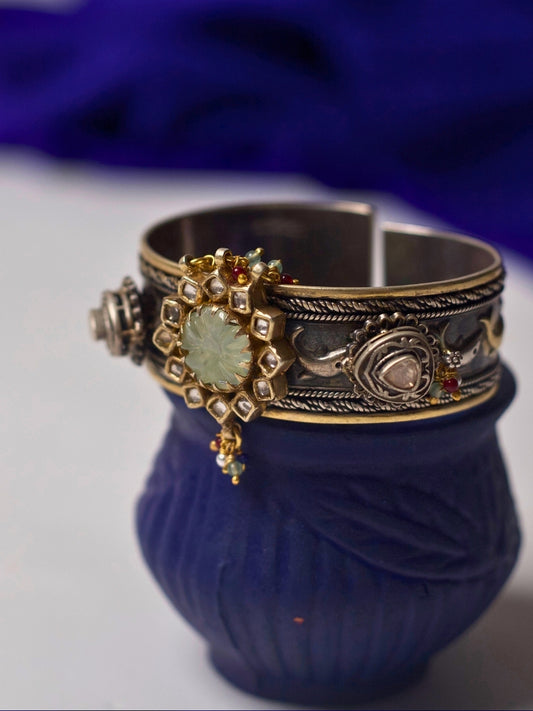92.5 silver cuff bracelet with floral carving, kundan accents, heritage motifs, and gold-silver dual tone from Naksa’s fusion collection