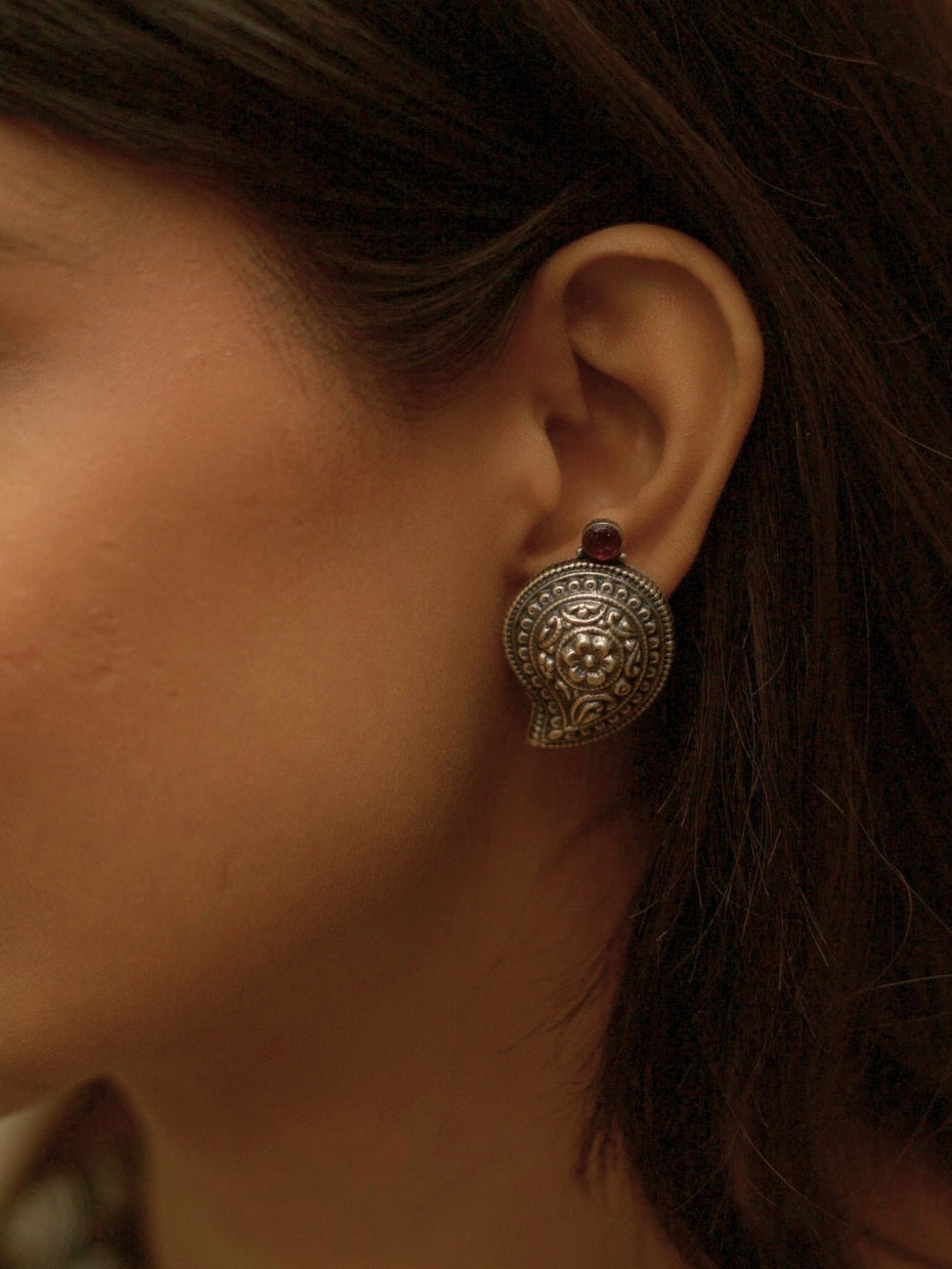 Temple Ambi Set by Naksa—oxidized 925 silver necklace and stud earrings with paisley motifs and wine-red accents.