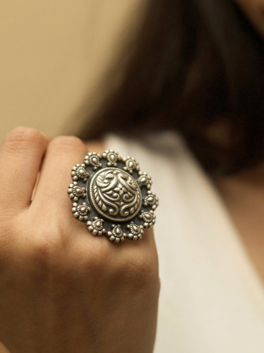 Shubhra Ring by Naksa—oxidized 925 silver statement ring with central carving and beaded floral border, inspired by temple motifs.