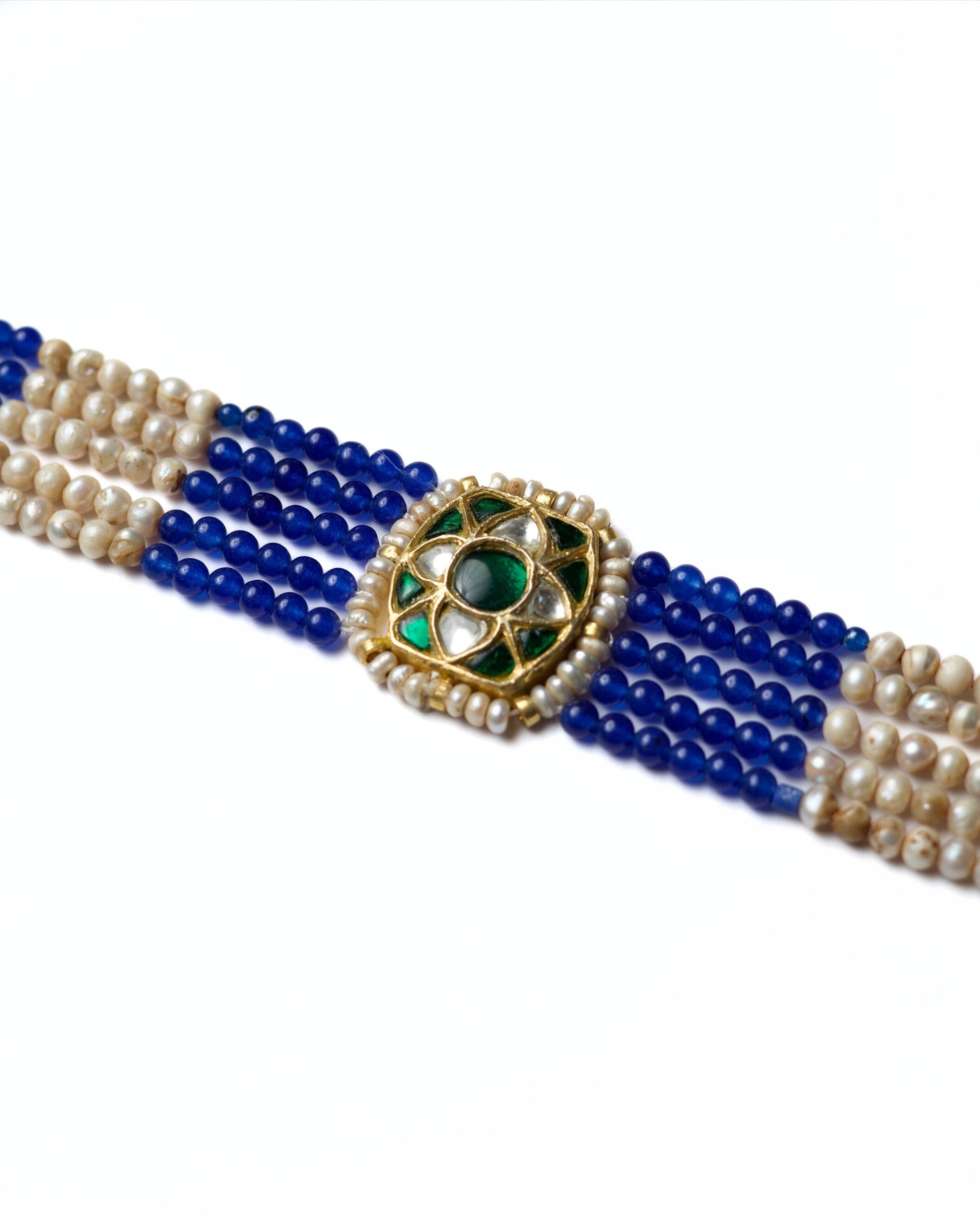 Blue and pearl striped choker in 925 silver with gold polish and kundan-set green centre stone by Naksa