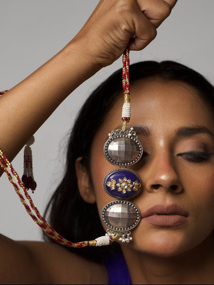 Close-up of Nightfall Empress Choker in pure 92.5 silver featuring a lapis centre with kundan and two faceted silver domes, styled on model's neck.