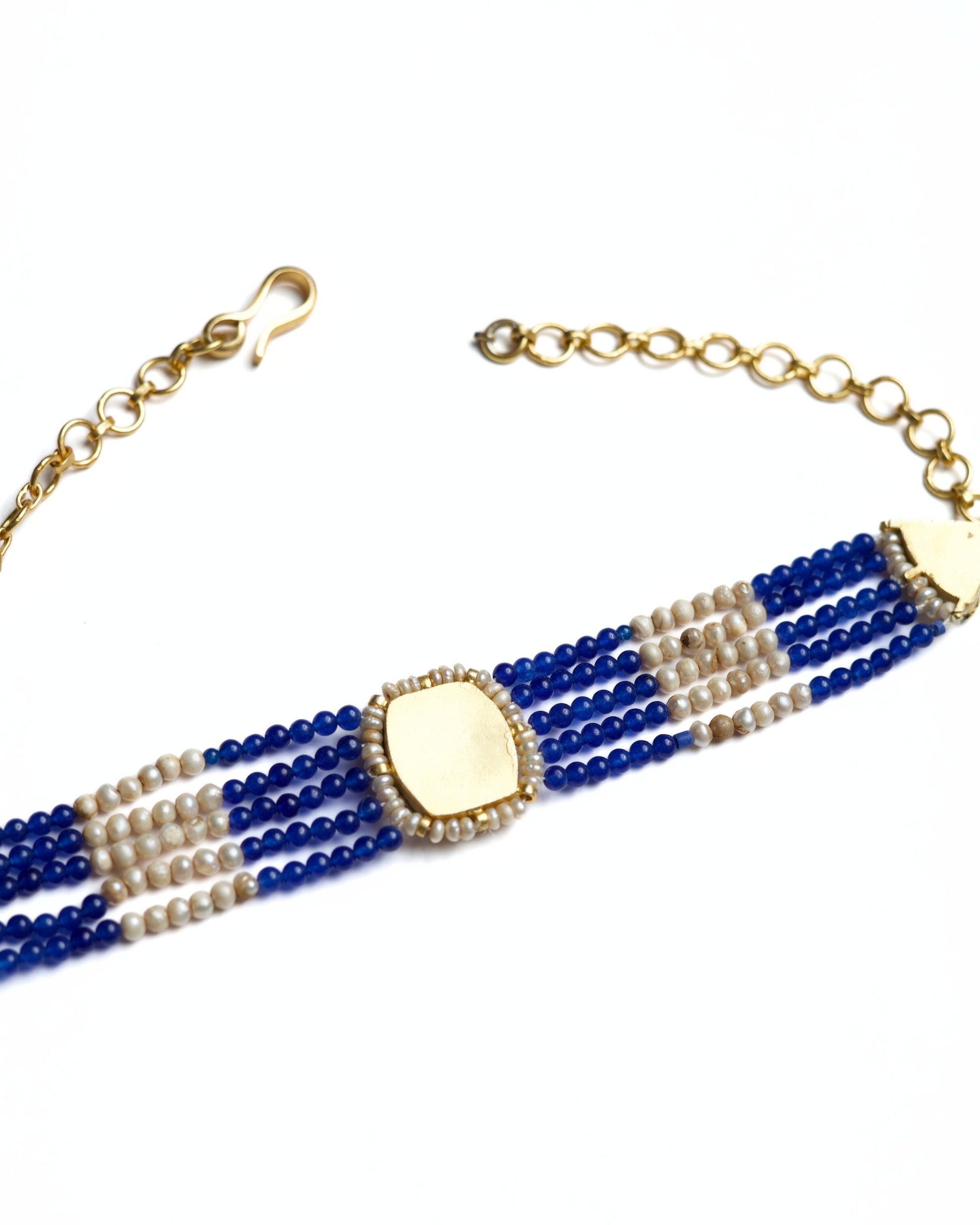 Blue and pearl striped choker in 925 silver with gold polish and kundan-set green centre stone by Naksa