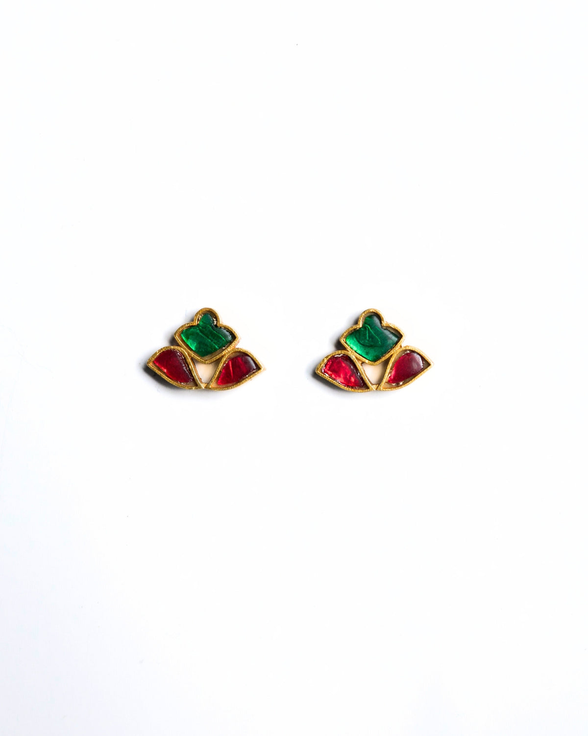 Close-up of red and green stone stud earrings in a fan-shaped mosaic design crafted in gold polished 925 silver.