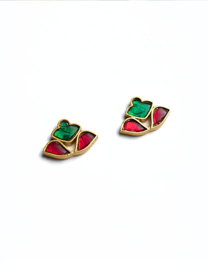 Close-up of red and green stone stud earrings in a fan-shaped mosaic design crafted in gold polished 925 silver.