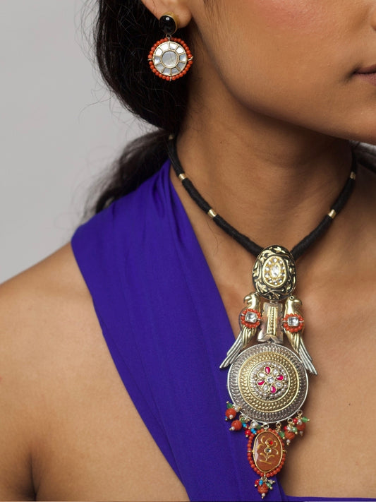 Close-up of The Courtship Collar Set – handcrafted silver necklace with twin parrot motifs, kundan inlays, enamel work, and matching round earrings from Naksa.