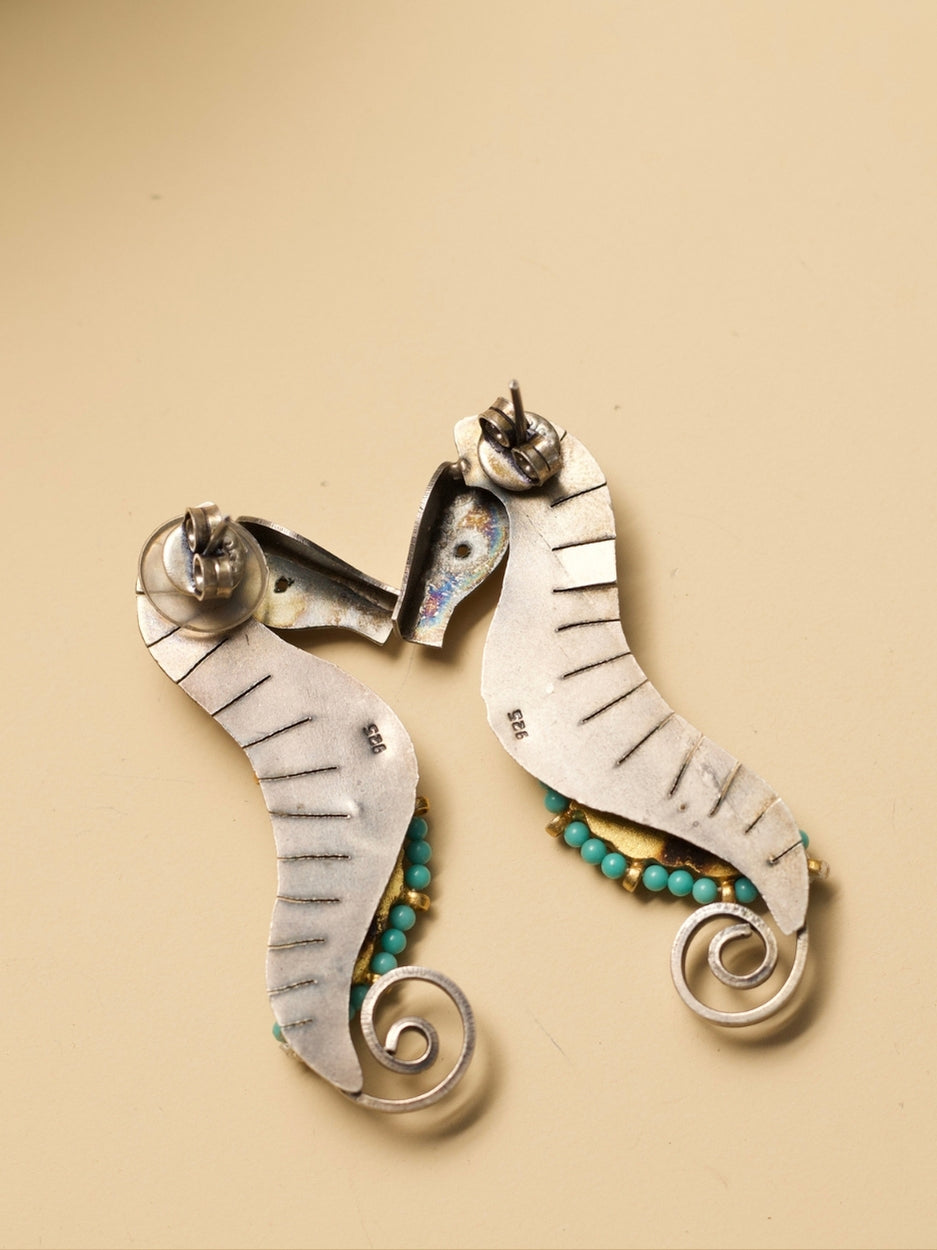 The Adorned Sea Horse Earrings by Naksa—oxidized 925 silver with bead detailing in pink, green, and turquoise.