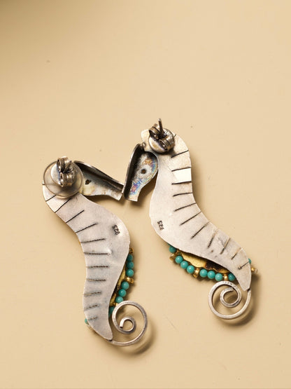 The Adorned Sea Horse Earrings by Naksa—oxidized 925 silver with bead detailing in pink, green, and turquoise.