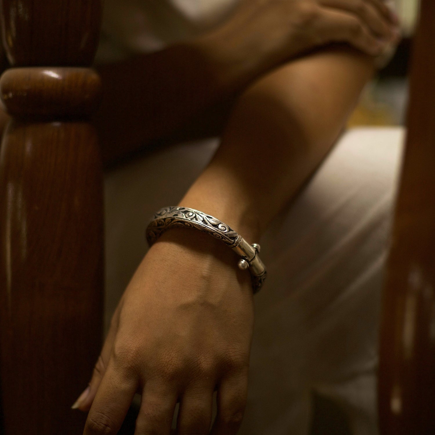 With winding vines nodding to the wisdom flowing through millenniums and the rustic dark finish of oxidised silver, this handcrafted engraved silver bangle comes with an adjustable toggle clasp. This bangle fits perfectly on your wrists and is durable and lightweight.