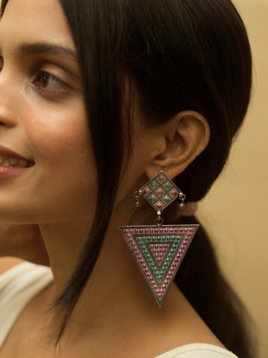 Nomad Angles Danglers by Naksa—oxidized 925 silver earrings with pastel pink and sea green enamel in geometric triangle and square motifs.