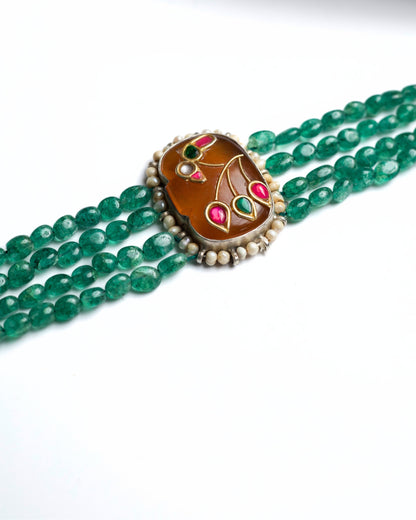 Four-strand green beaded 925 silver choker with gold-polished oval centre, pearl border and pink-green bird motif detailing.