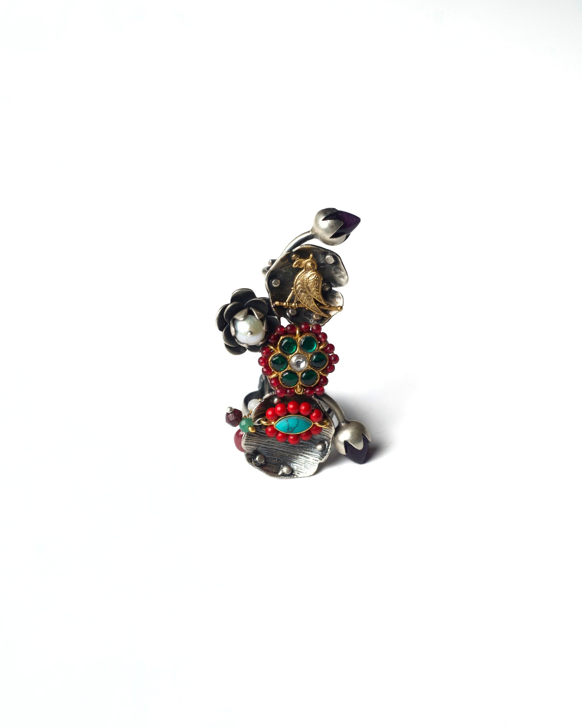 Front view of Ruby Gardenia Ascend Full Finger Ring in 925 silver, featuring a vertical garden-inspired composition with layered floral motifs, bird detailing, ruby-toned stones, and curved silver bands.