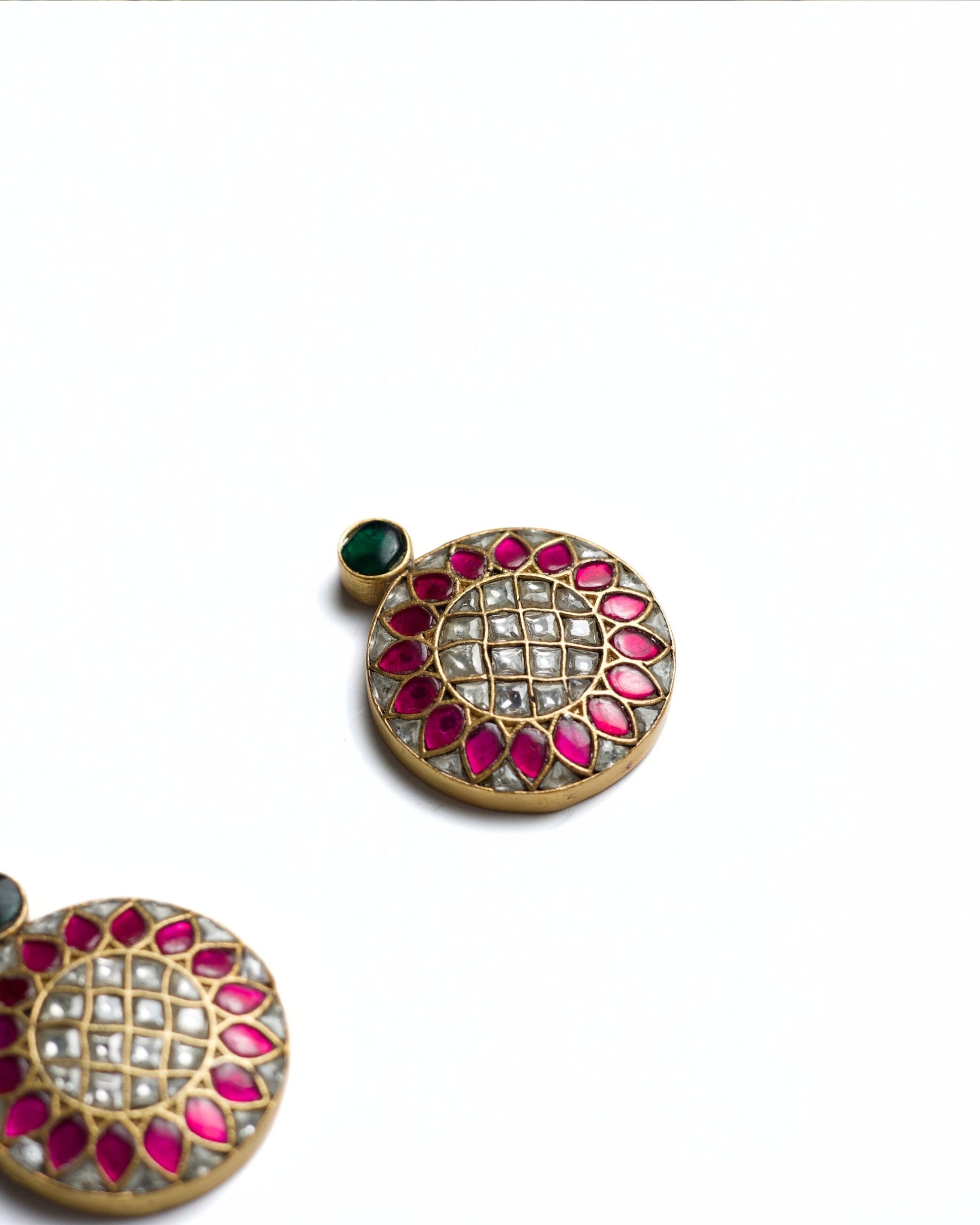 Round pink and white kundan stud earrings in gold polished 925 silver with green top stone accent.