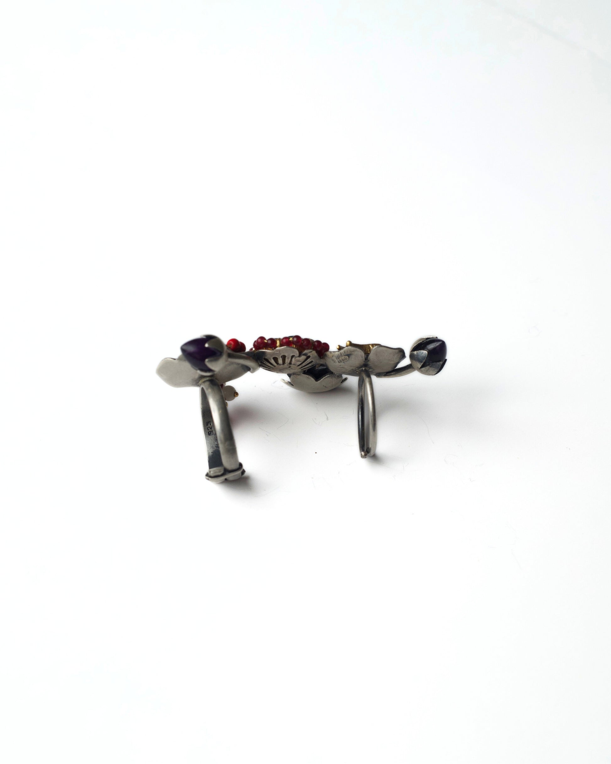Side view of Ruby Gardenia Ascend Full Finger Ring in 925 silver, showing the sculptural curved bands, raised floral cluster, bird motif placement, and multi-layered full-finger structure.