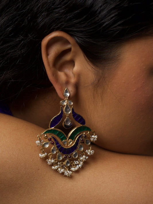 Close-up of Kalgi Silver Earrings in 92.5 silver featuring kundan stones, green and purple enamel, and pearl detailing.