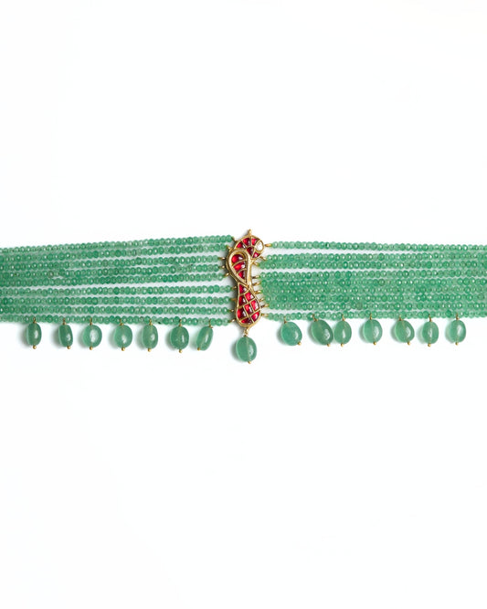 Green multi-strand beaded 925 silver choker with gold polish, red kundan-style bird motif at centre, and dangling green stone drops along the base.