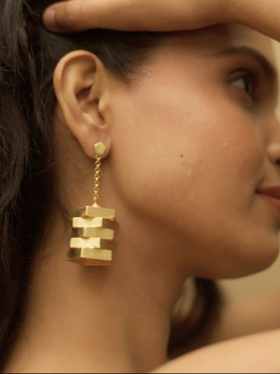 The Golden Hour Earrings by Naksa—matte gold polished sculptural 925 silver earrings with stacked geometric silhouette.