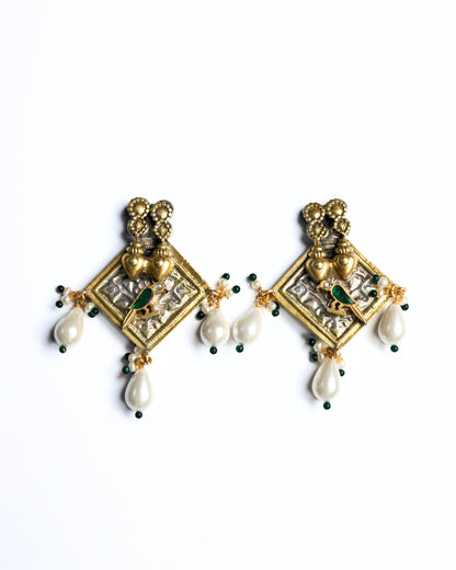 Gold polished 925 silver square earrings with twin heart detailing, green bird motif, and white pearl drop danglers.