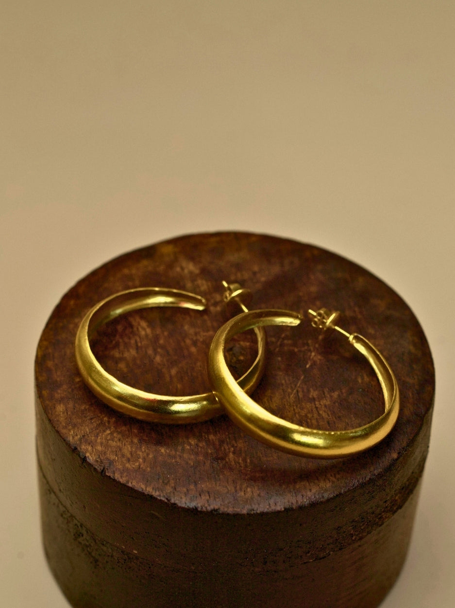 Hoops for Good earrings by Naksa—pure 925 silver gold small hoop earrings with smooth finish.