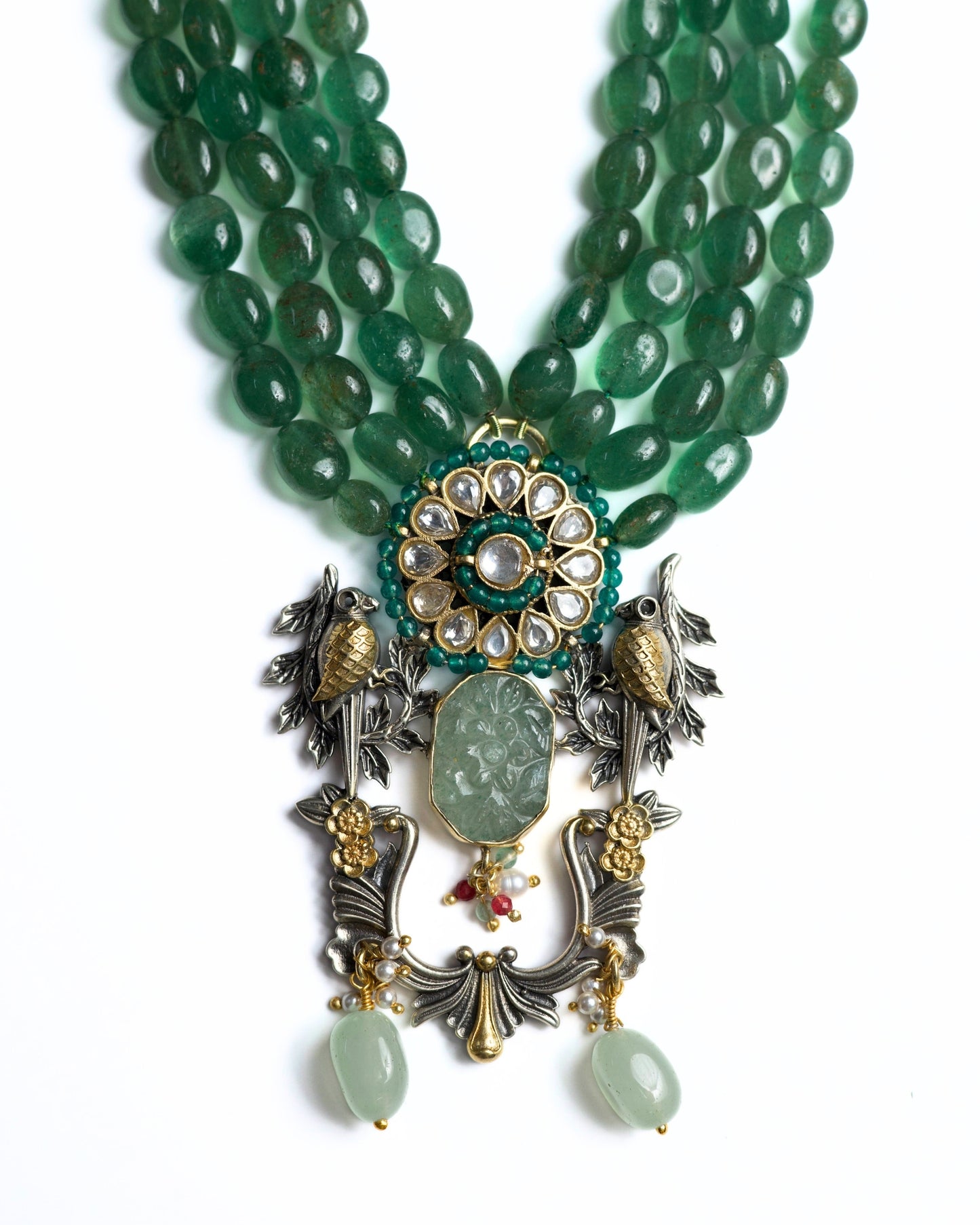 Four-strand green jade bead necklace in 925 silver with gold-plated kundan floral centre, twin bird motifs, carved jade drop, and decorative hanging elements.