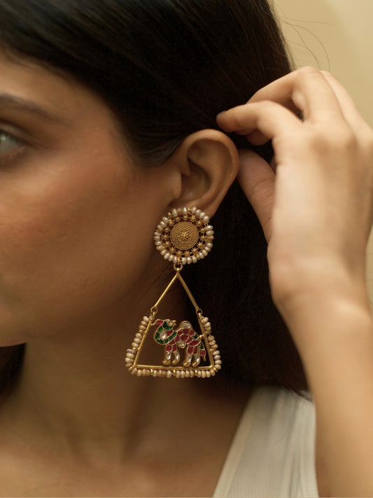Safar Nama Earrings – Rang Birangi by Naksa, pure 925 silver with gold polish, pink-green enamel camel motif, triangle frame and pearl accents.