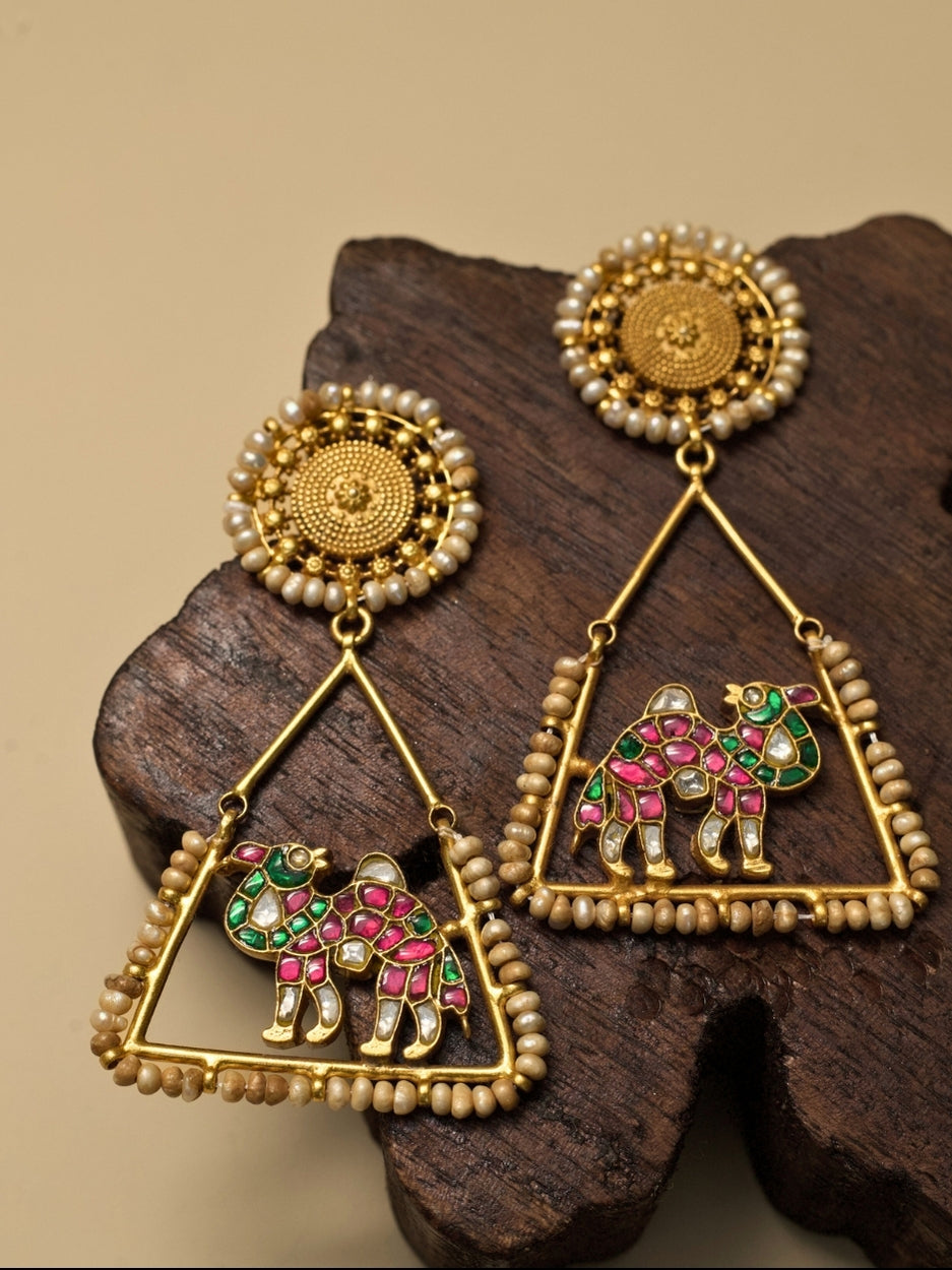 Safar Nama Earrings – Rang Birangi by Naksa, pure 925 silver with gold polish, pink-green enamel camel motif, triangle frame and pearl accents.