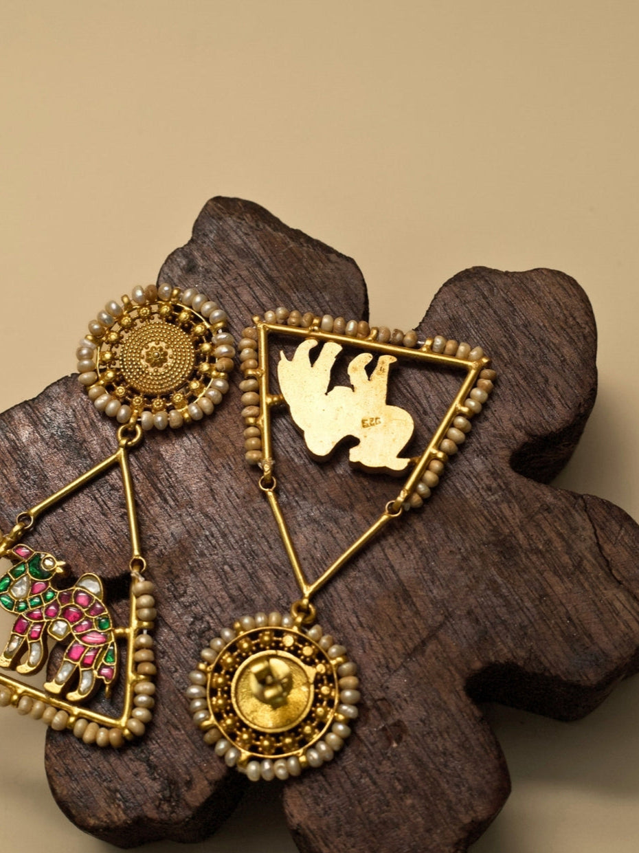 Safar Nama Earrings – Rang Birangi by Naksa, pure 925 silver with gold polish, pink-green enamel camel motif, triangle frame and pearl accents.